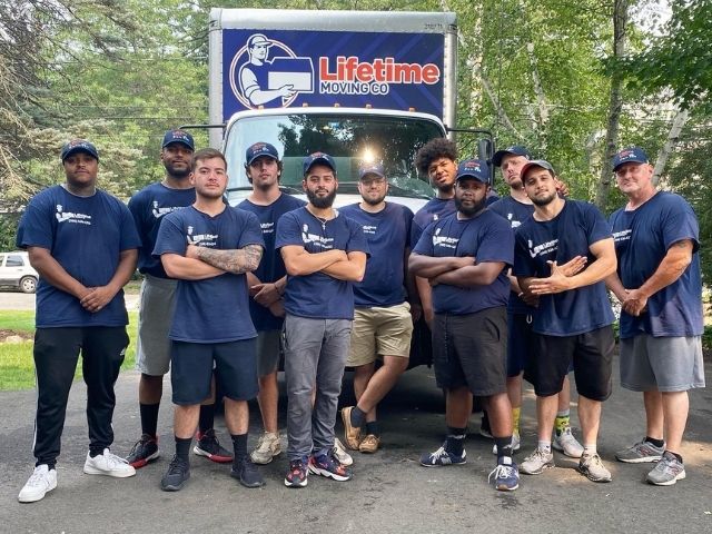 Lifetime Moving Co team carefully wrapping furniture for a Senior Movers move in Brighton, MA using protective materials and labeling system.