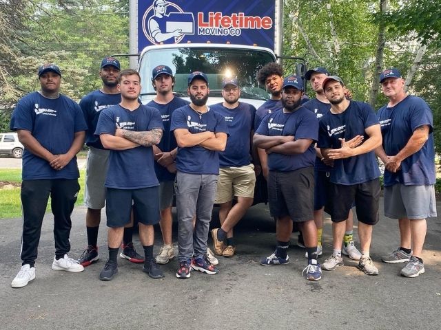 Lifetime Moving Co team organizing household items for a Senior Movers move in Brookline, MA with professional packing supplies and attention to detail.