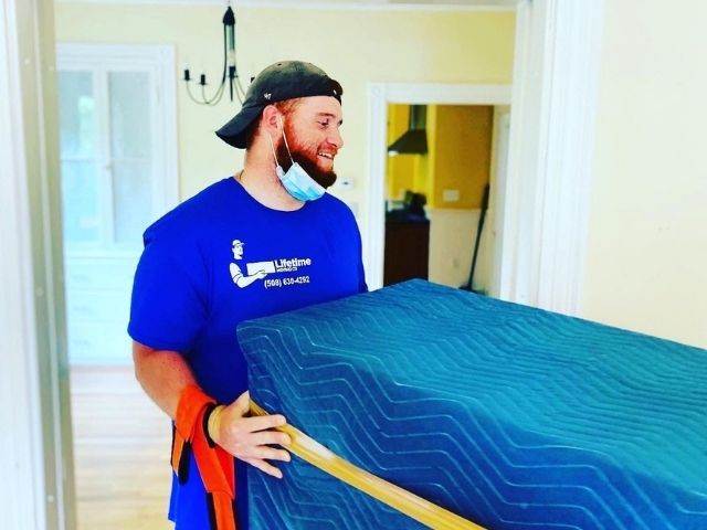 Lifetime Moving Co mover protects furniture while completing a careful apartment move in Northborough, MA.